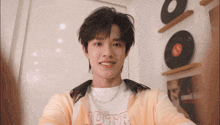 a young man taking a selfie with a t-shirt that says 10thr on it