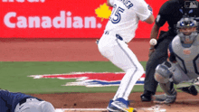 a baseball player with the number 25 on his jersey is swinging at a pitch