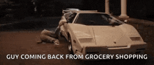 a man is laying on the ground next to a white sports car with the words `` guy coming back from grocery shopping '' .