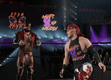 two wrestlers are in a ring with a sign that says adam payne