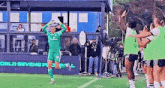 a soccer player in a green uniform with the number 91 on it