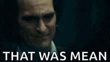 a close up of a man crying with the words `` that was mean '' above him .