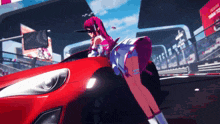 a girl standing next to a red car with a sign that says toyota on it