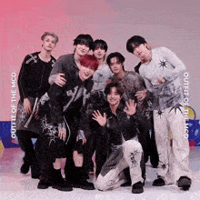 a group of young men are posing for a picture with the words outfit of the mcd behind them