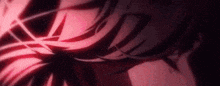 a close up of a person 's face with a red light coming out of it in a dark room .