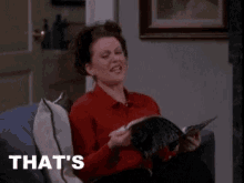 a woman is sitting on a couch reading a magazine and says that 's enough ..