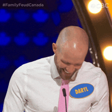 a man in a white shirt and pink tie has a name tag that says daryl