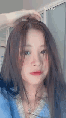 a girl in a blue shirt with the words let 's go written on the bottom