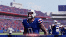 a football player for the buffalo bills stands on a field