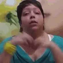 a woman is making a heart with her hands .