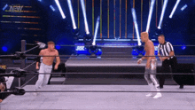 a man in a wrestling ring with a aew logo on the wall