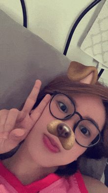 a girl wearing glasses and a dog mask giving the peace sign