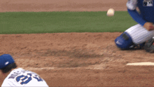 a baseball player wearing a blue nike jersey is kneeling down