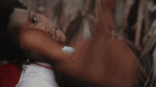 a man wearing a watch and a necklace has a tattoo on his arm that says ' i 'm sorry '