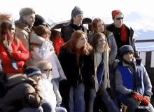 a group of people are posing for a picture and one of them is wearing a hat that says ' rbd ' on it