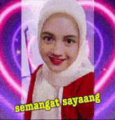 a woman wearing a hijab with the words semangat sayaang written below her