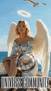 a woman with angel wings is sitting on a beach with a coin that says universe community