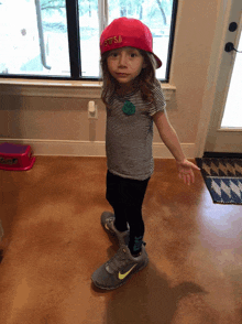 a little girl wearing a hat that says texas