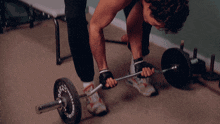 a man is lifting a barbell with a plate that says 50 on it