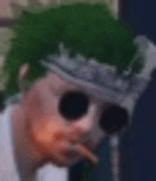 a close up of a person 's face with sunglasses and a green hat .