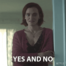 a woman in a red cardigan stands in front of a sign that says " yes and no "