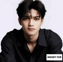 a young man in a black shirt has the name mickey fcr on the bottom right