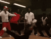 a group of people are dancing together in a gym