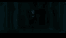 a man in a tuxedo is walking in the dark .