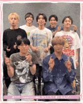 a group of young men are posing for a picture with one wearing a walt disney t-shirt