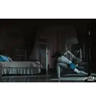 a person is doing a yoga pose in a bedroom