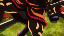 a close up of a person 's leg with a sword in the grass