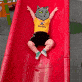 a child wearing a yellow shirt that says steelers is going down a slide