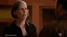 a woman is talking to a man in a chicago fire episode