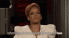 a woman in a white dress is sitting in a chair and saying ohmygodmygodmygodfuse .
