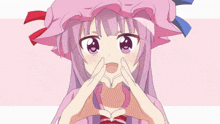 a girl with purple hair and a pink hat making a heart shape with her hands