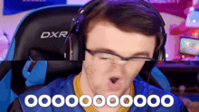a man wearing glasses and headphones is sitting in a dxr chair .