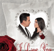 a white pillow with a picture of a man and woman in a heart shaped frame