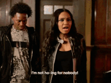 a woman says i 'm not ho-ing for nobody while standing next to a man in a black jacket