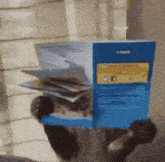 a person is holding a vtech box in their hand