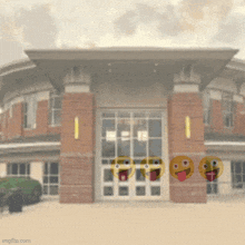 a blurred image of a brick building with emoji faces on it