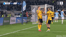 a soccer player wearing a yellow jersey with the number 33 on it celebrates a goal