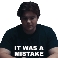 a man wearing a black shirt with the words it was a mistake written on it
