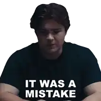 a man wearing a black shirt with the words it was a mistake written on it