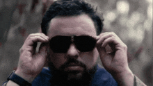 a man with a beard is wearing sunglasses