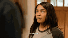 a woman says oh my god while standing in front of a window