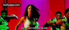 a woman is dancing with a group of men and says no no i don t like them like that