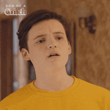 a close up of a boy 's face with the words son of a critch below him