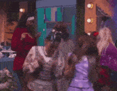 a group of young women are dancing in a room