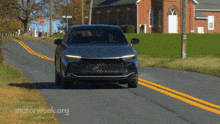 a car is driving down a road with motorweek.org written on the bottom right