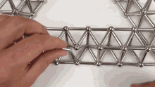 a person is playing with a set of magnetic balls and sticks